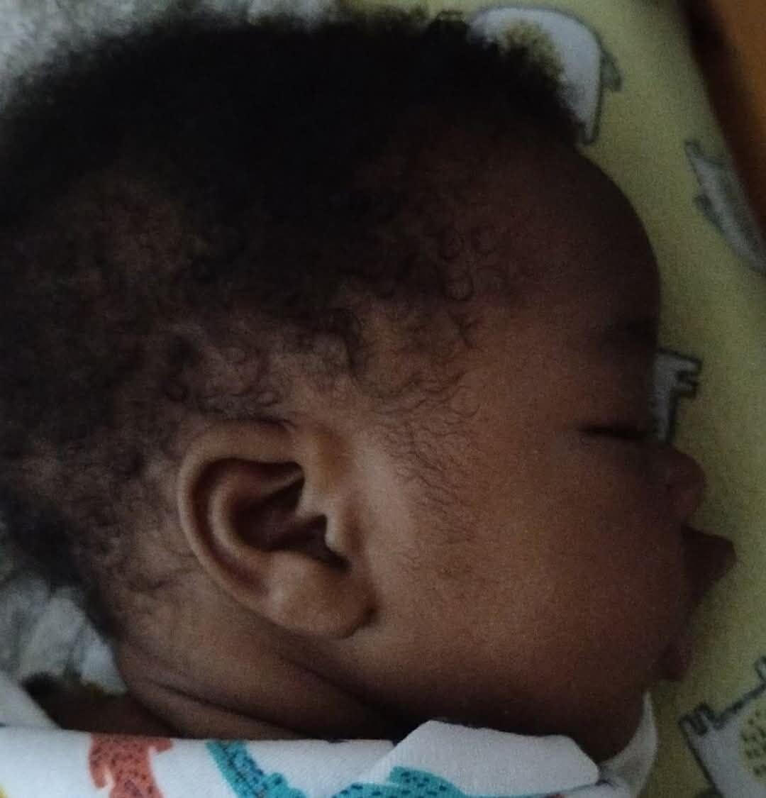 baby sindi with clean fresh clothes and about to prepare herself for feeding